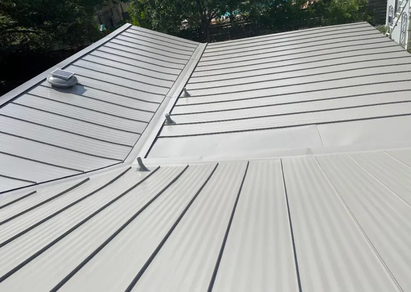 Solar attic fan installed on a metal roof for Roof Ventilation in Bessemer City